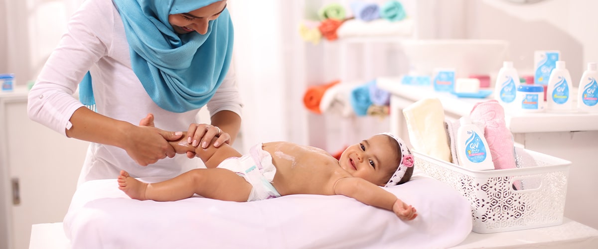 Cute baby wearing a soft, eco-friendly diaper, smiling in a cozy nursery